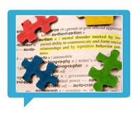 Puzzle pieces on a dictionary highlighting autism
